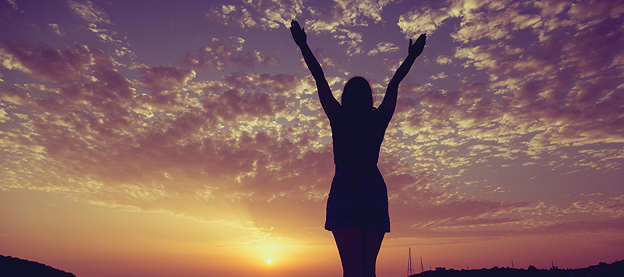 Young woman looking at the sunset